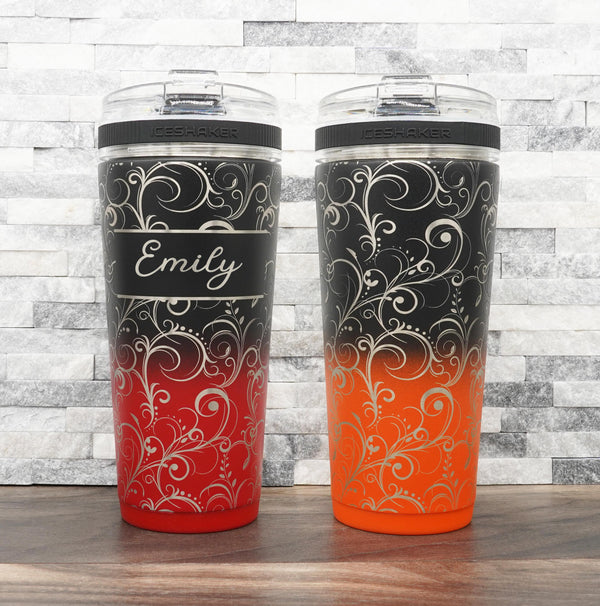 Ice Shaker Flex Bottle laser engraved with flourish pattern, shown both personalized and with just the design, in the black/red two-tone finish and black/orange two-tone finish.