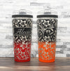 Ice Shaker Flex Bottle laser engraved with lily pattern, shown both personalized and with just the design, in the black/red two-tone finish and black/orange two-tone finish.