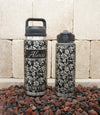 Yeti and Polar Camel water bottles laser-engraved with hibiscus flower pattern full wrap-around design.