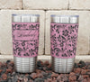 Leatherette-wrapped insulated stainless steel tumbler laser-engraved with hibiscus flower pattern.