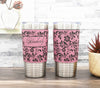 Leatherette-wrapped insulated stainless steel tumbler laser-engraved with hibiscus flower pattern.