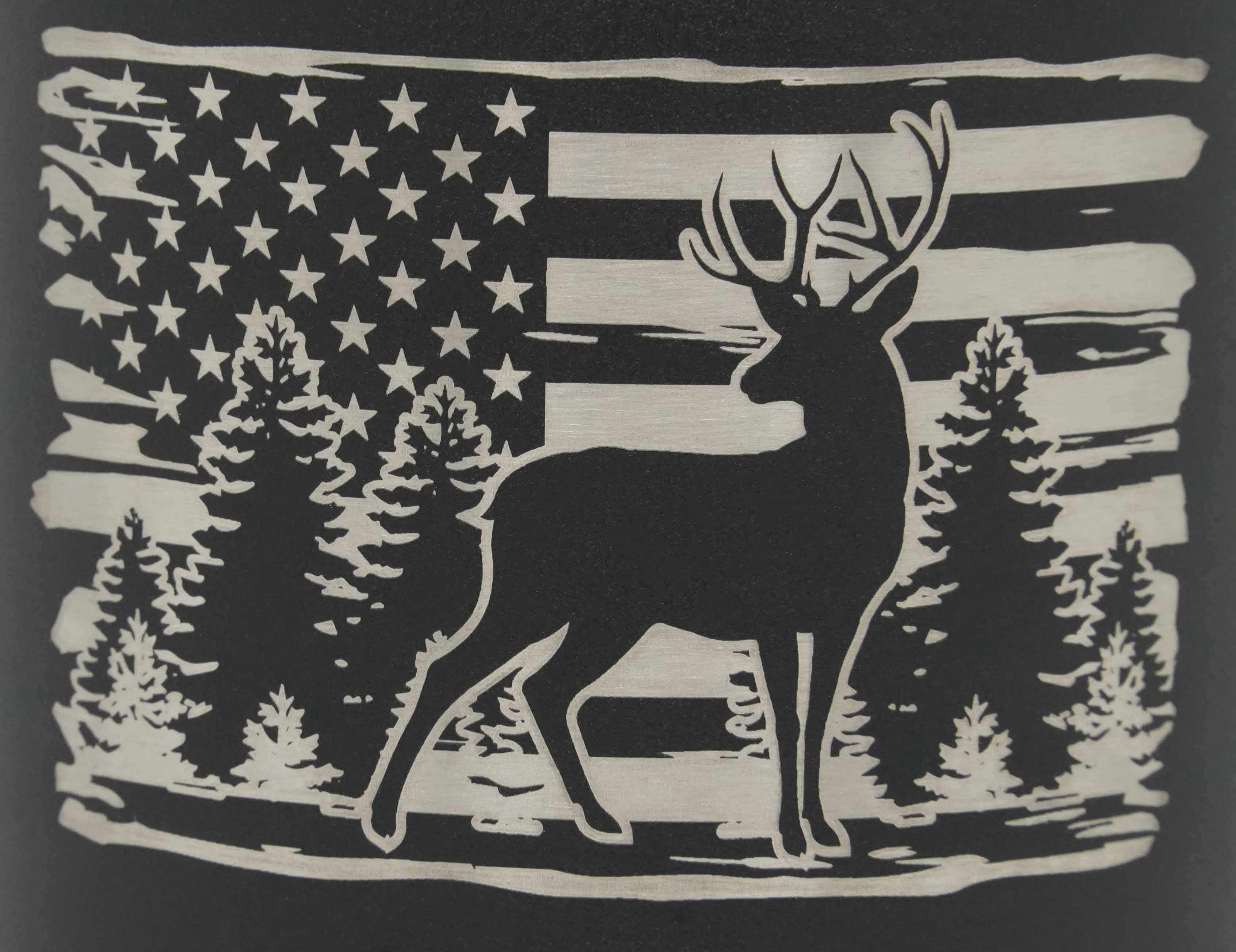 Zoom in showing detail of laser engraved deer among trees with distressed American flag scene